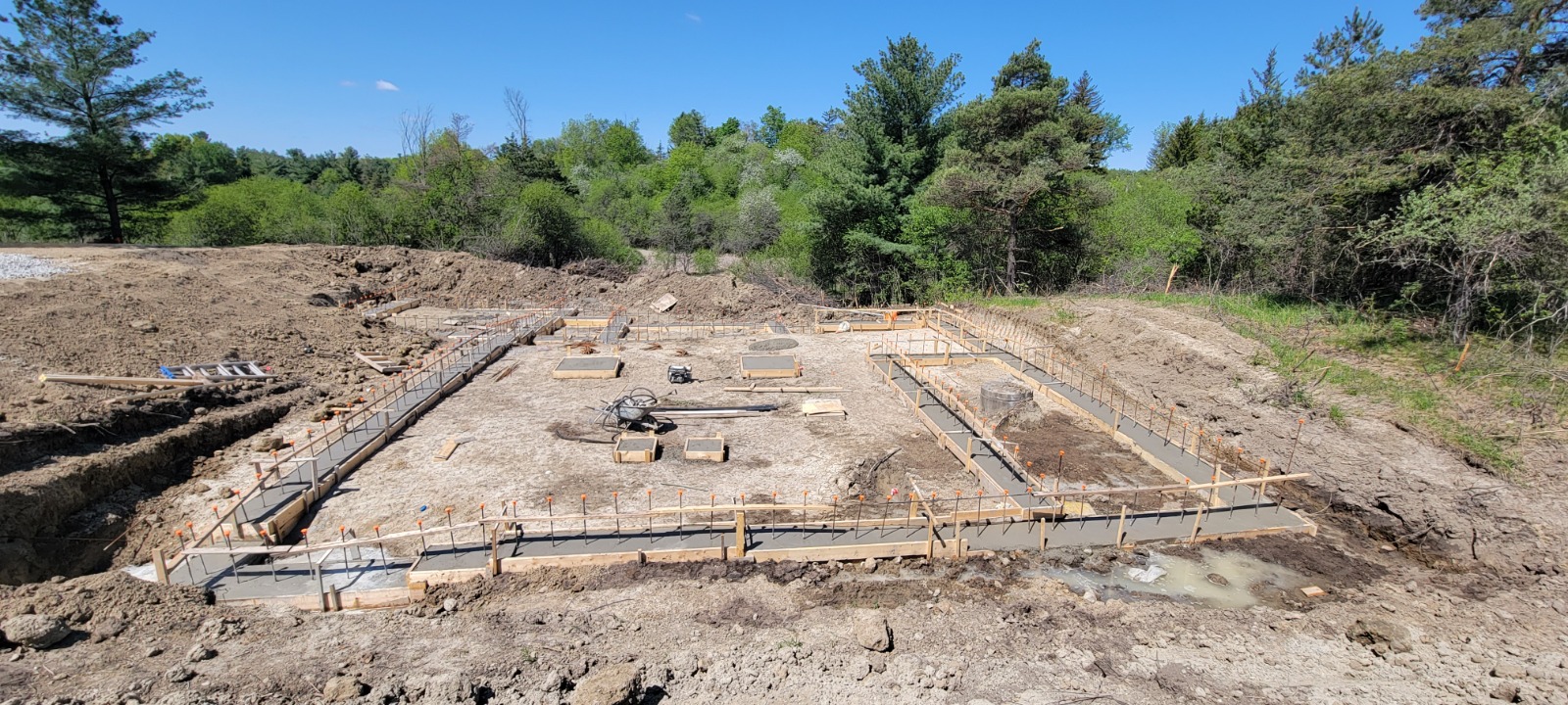Custom home foundation stage with concrete formwork before framing and exterior finishes