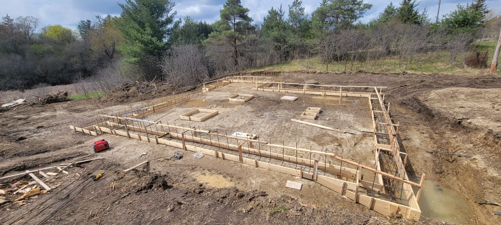 Wood footing forms and reinforcing steel prepared for the custom home foundation