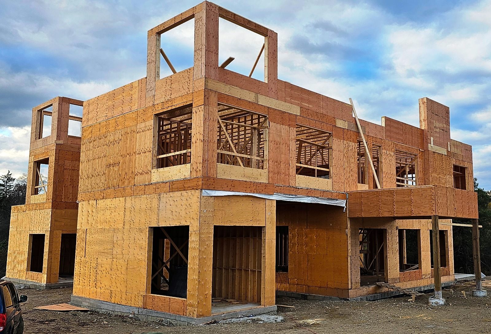 Custom home framing stage with wood structure and window openings