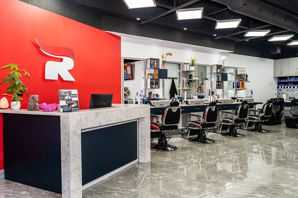 Finished hair salon reception area with seating, feature lighting, and coordinated finishes