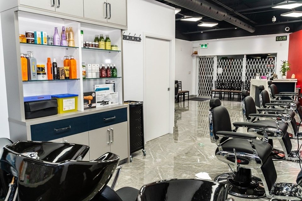 Finished commercial salon buildout with styling stations, polished flooring, and custom cabinetry