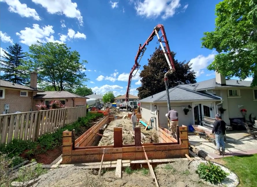 Concrete foundation pour underway for the attached garage addition